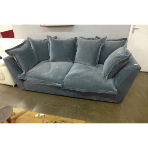 1388 - A designer blue weave velvet, curved back three seater sofa