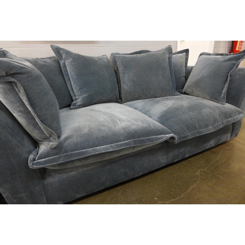 1388 - A designer blue weave velvet, curved back three seater sofa