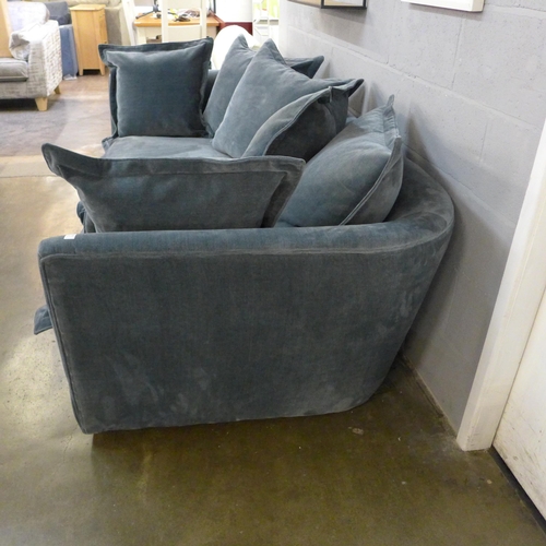 1388 - A designer blue weave velvet, curved back three seater sofa