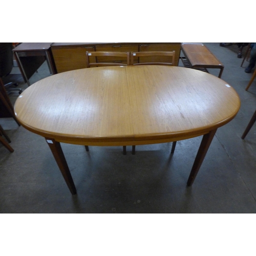 68 - A teak extending dining table and four chairs