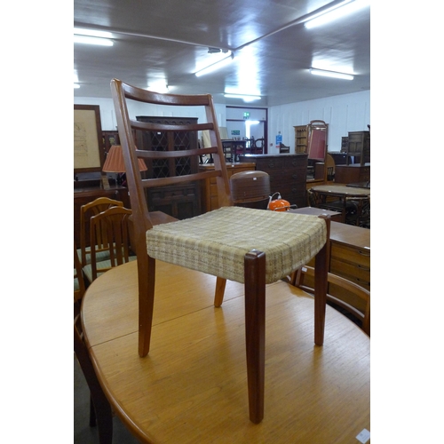 68 - A teak extending dining table and four chairs