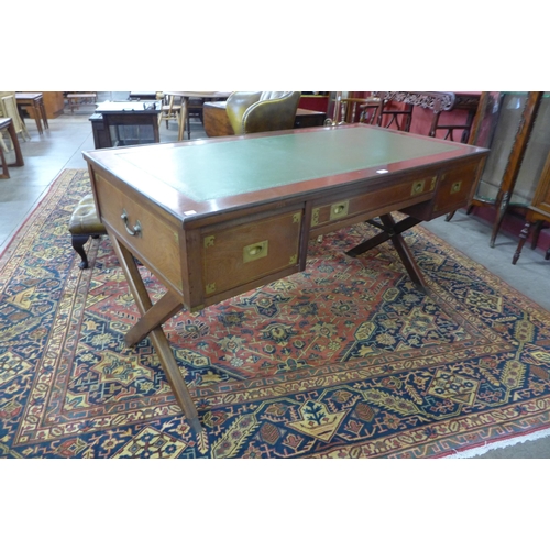 49 - A mahogany, brass mounted and green leather topped military/campaign style desk