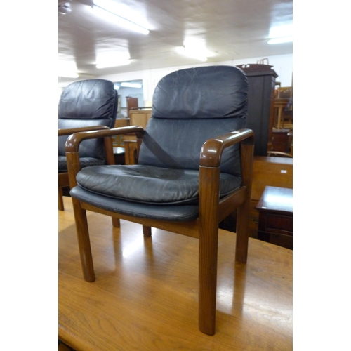 101 - A pair of Danish Dyrlund teak and blue leather armchairs