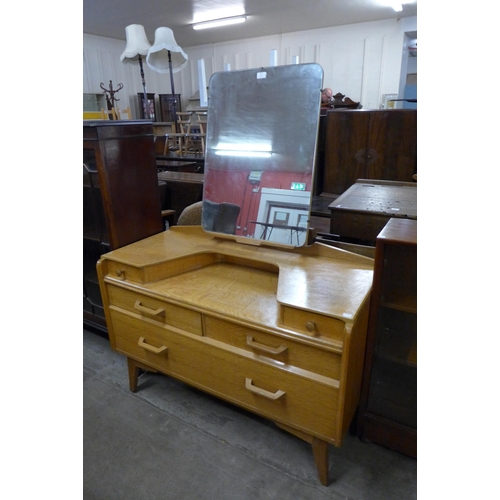 122 - A G-Plan Brandon oak dressing table, chair and bedside cabinet