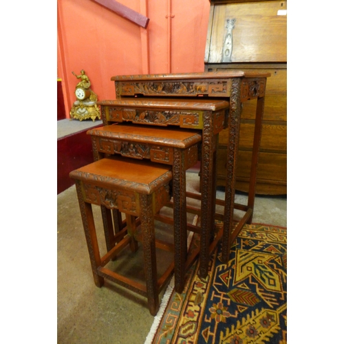 18 - A Chinese carved hardwood nest of quartetto tables