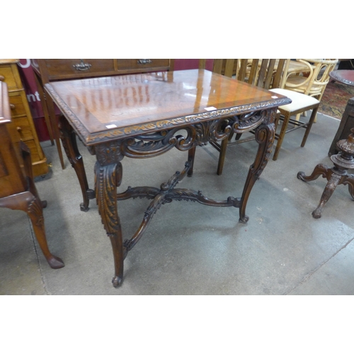 21 - An Italian Rococo Revival carved walnut centre table