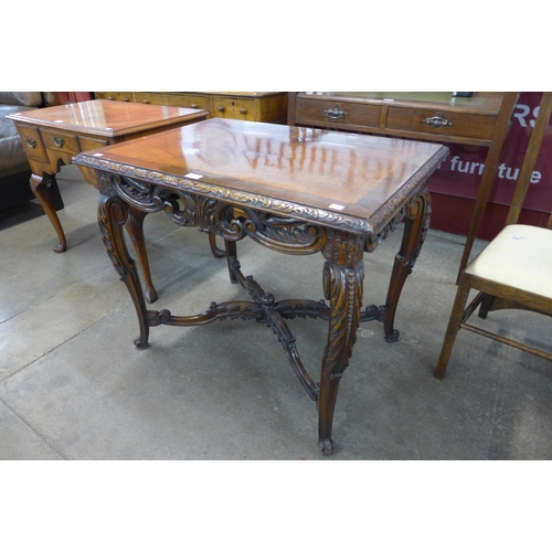 21 - An Italian Rococo Revival carved walnut centre table