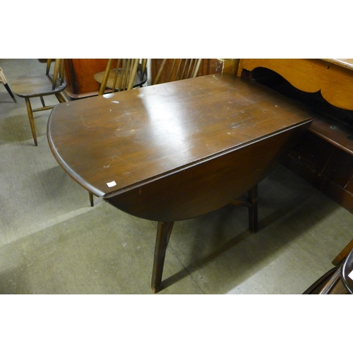 220 - A set of four Ercol dark elm and beech Goldsmith chairs and a drop leaf table