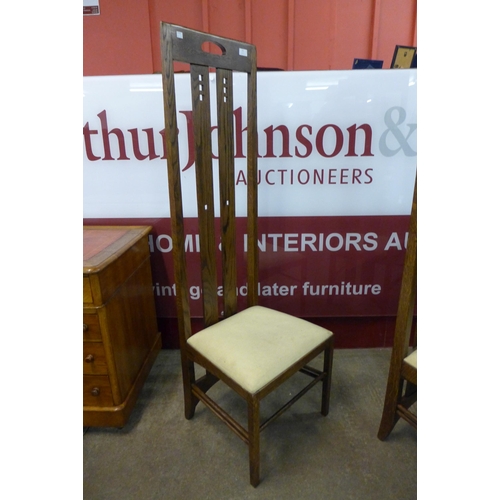 25 - A pair of Arts and Crafts style oak highback chairs, after Charles Rennie Mackintosh