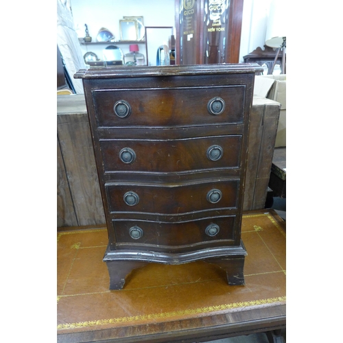 253 - A small mahogany serpentine chest and a mahogany and leather topped drop-leaf coffee table