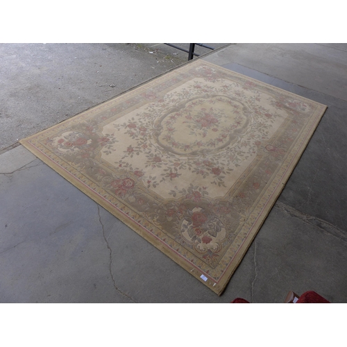 264 - A large beige ground rug, 298 x 200cms