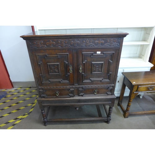 37 - A 17th Century style carved oak cabinet on stand