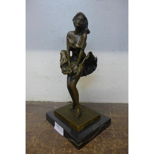 425 - A bronze figure of Marilyn Monroe, on black marble socle