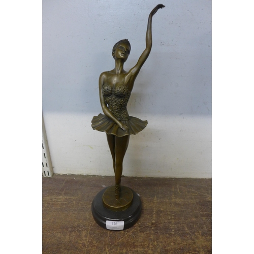 426 - A bronze figure of a ballerina, on black marble socle