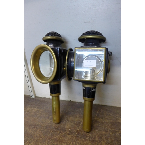 428 - A pair of brass and black steel railway carriage lights