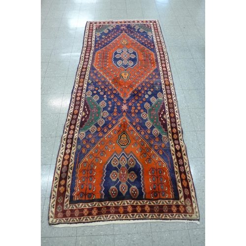 47 - A hand knotted North West Iranian red ground runner rug, 314 x 132cms