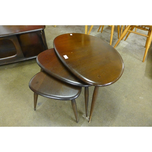 52 - An Ercol dark elm and beech pebble shaped nest of tables