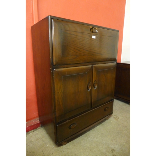 58 - An Ercol dark elm writing cabinet