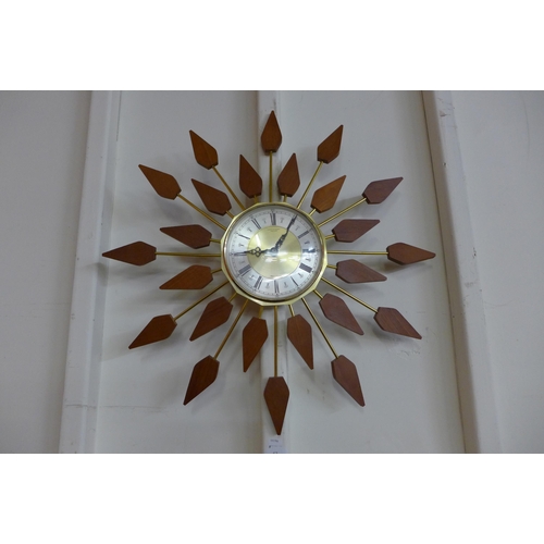 62 - An Anstey & Wilson teak and brass wall clock