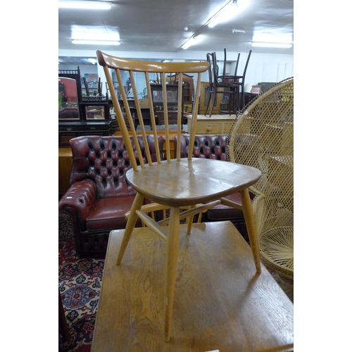 84 - An Ercol Blonde elm and beech drop-leaf table and two chairs