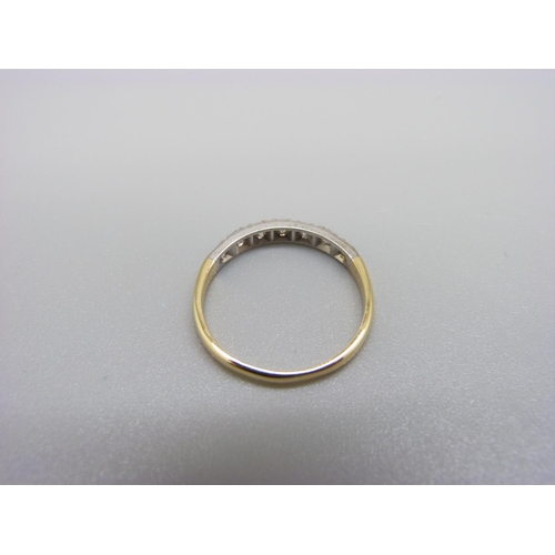 1003 - An 18ct gold, seven stone diamond half eternity ring, 2.2g, O