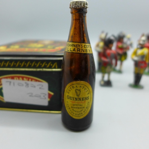 632 - Ten lead soldiers and a Guinness miniature