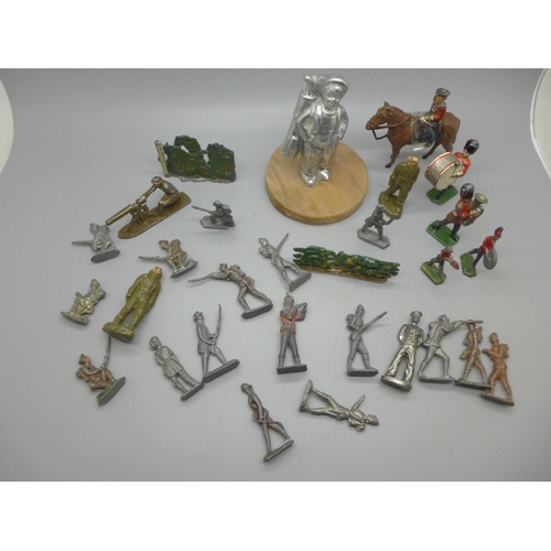 718 - A collection of lead figures and a golf caddy car mascot