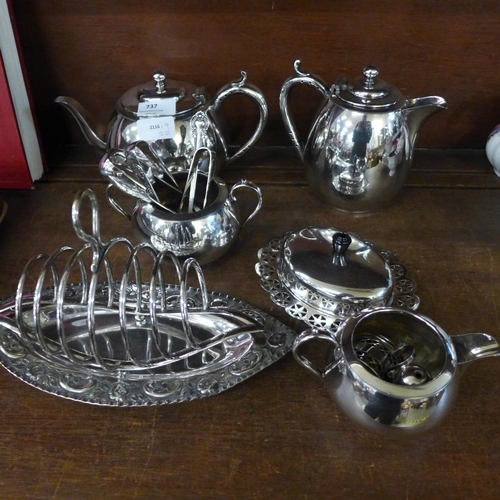 737 - A four piece plated tea service, a navette shaped plated tea service, a cruet, a butter dish, three ... 