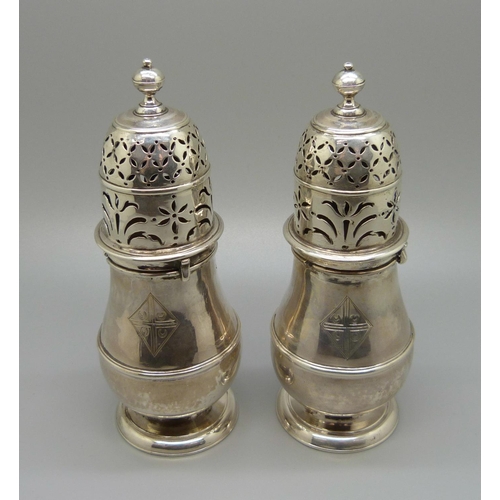 893 - A pair of early 18th Century silver sugar shakers, London mark, 227g, 14cm