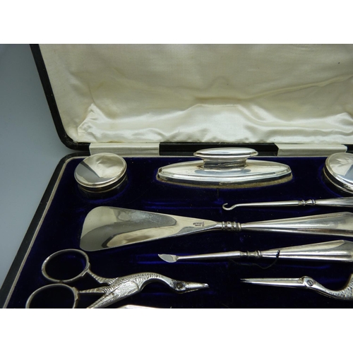 957 - A silver mounted manicure set, boxed, replacement scissors