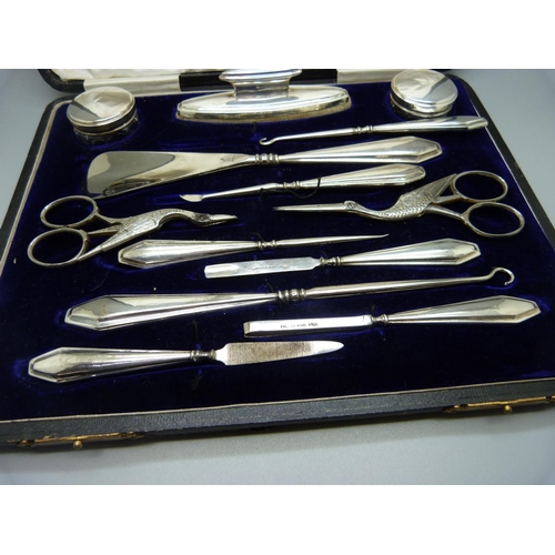 957 - A silver mounted manicure set, boxed, replacement scissors