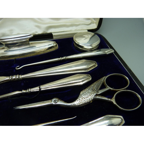 957 - A silver mounted manicure set, boxed, replacement scissors