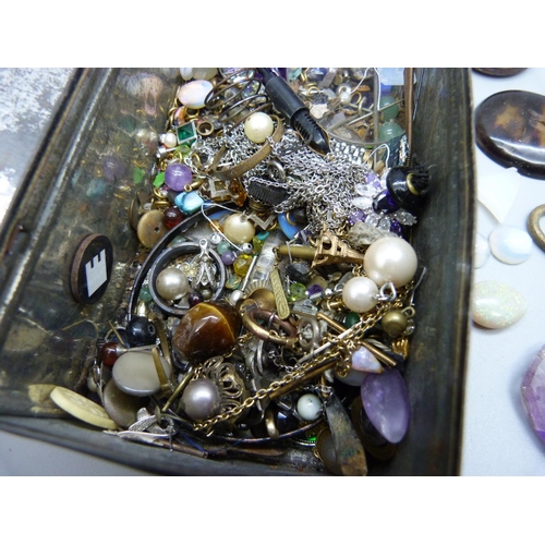 970 - A tin of jewellery, gemstone oddments, etc.