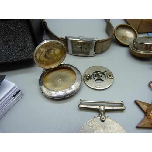 976 - Three WWII medals, two wristwatches, a small silver compact lacking mirror, sovereign case, a/f, and... 