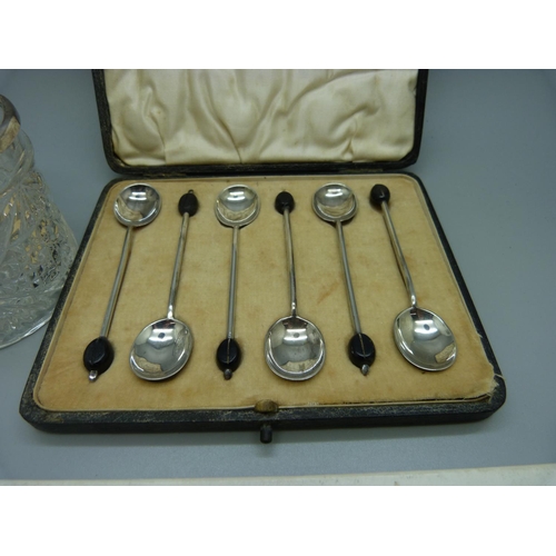 979 - Six silver coffee bean spoons, 50g, a silver handled pickle fork and a silver mounted glass jar