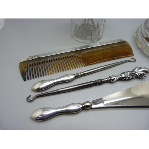 980 - A silver rimmed glass dish, a silver topped glass jar, a silver mounted comb, etc.