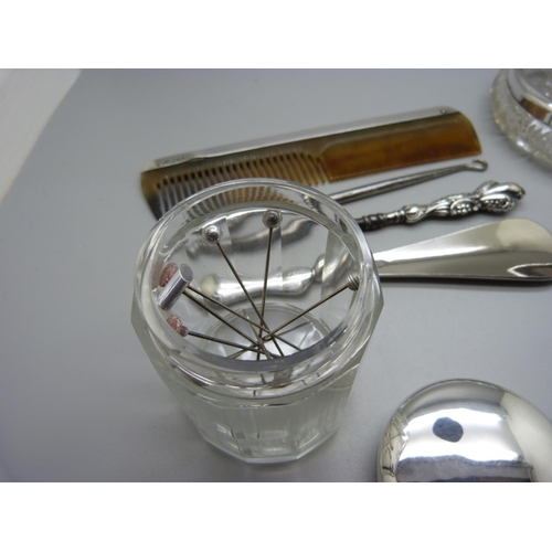 980 - A silver rimmed glass dish, a silver topped glass jar, a silver mounted comb, etc.