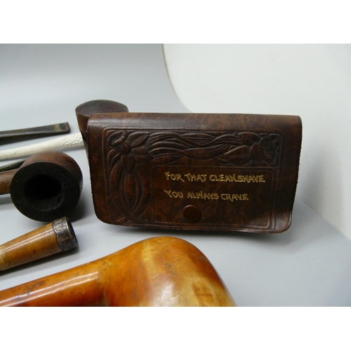 992 - A collection of pipes, a Bakelite cased razor and a Bakelite cased cigarette holder