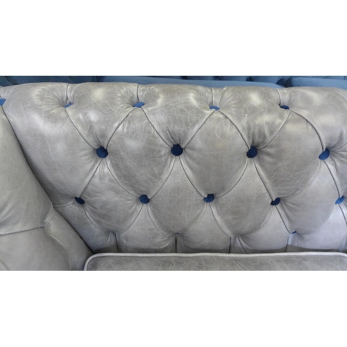 1471 - A grey leather and blue velvet buttoned three seater sofa