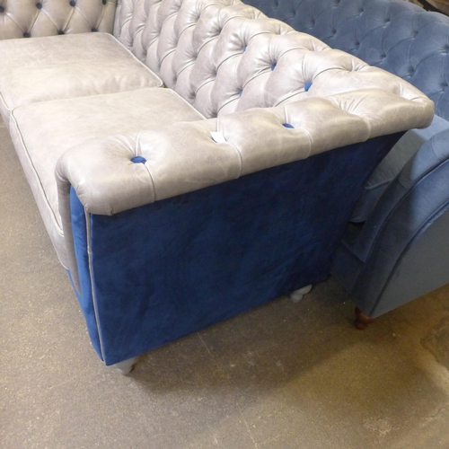 1471 - A grey leather and blue velvet buttoned three seater sofa