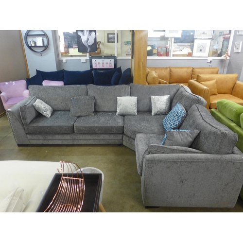 1503 - An ash grey upholstered studded corner sofa