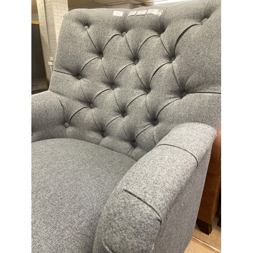 1349 - An Atlanta dark grey fabric button back armchair