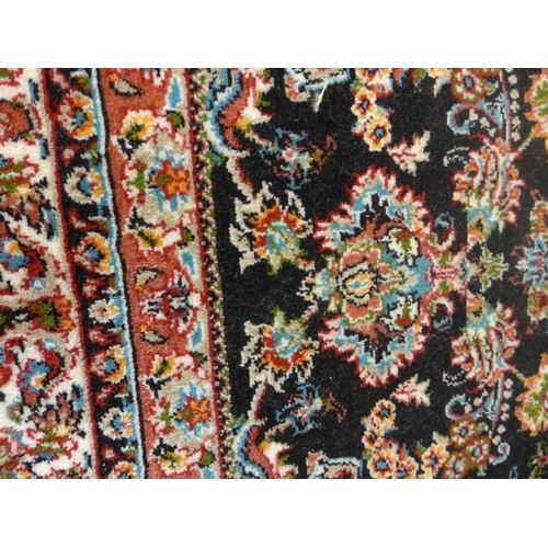 1642 - A black ground full pile Iranian carpet, all over floral design, 3 x 2m