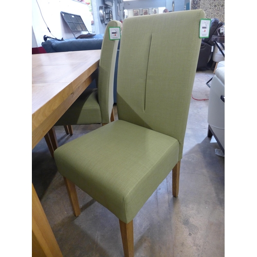 1360 - An oak extending dining table and a set of four green fabric dining chairs