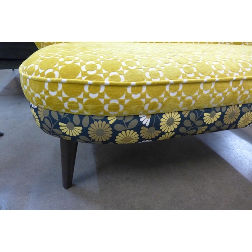 1365 - A marigold velvet and floral patterned upholstered two seater sofa