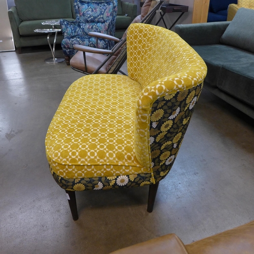 1365 - A marigold velvet and floral patterned upholstered two seater sofa