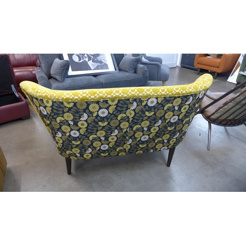 1365 - A marigold velvet and floral patterned upholstered two seater sofa