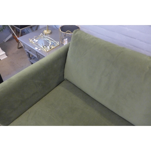 1369 - A forest green velvet upholstered three seater sofa