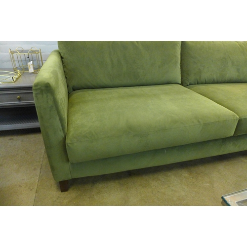 1369 - A forest green velvet upholstered three seater sofa