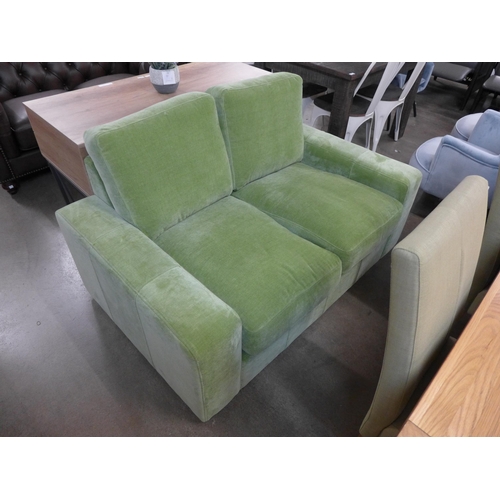 1373 - A lime green velvet two seater sofa